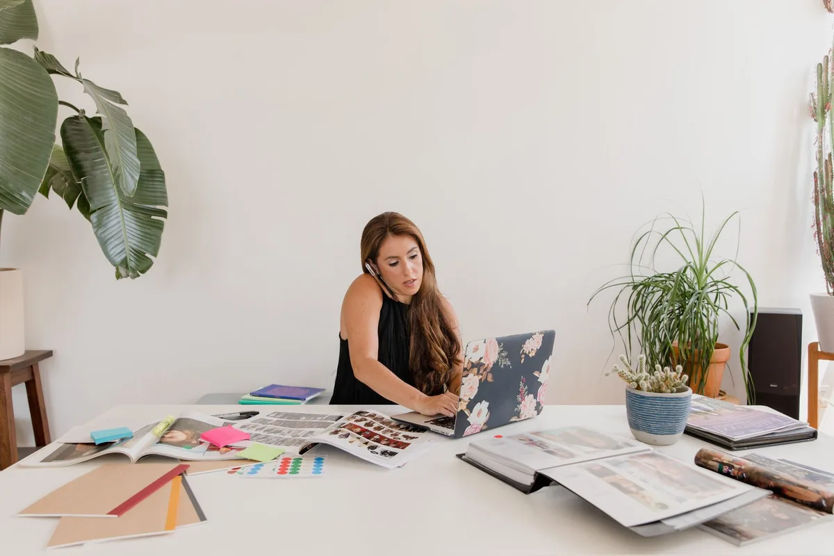 Small business owner reviewing financial documents and loan paperwork at desk
