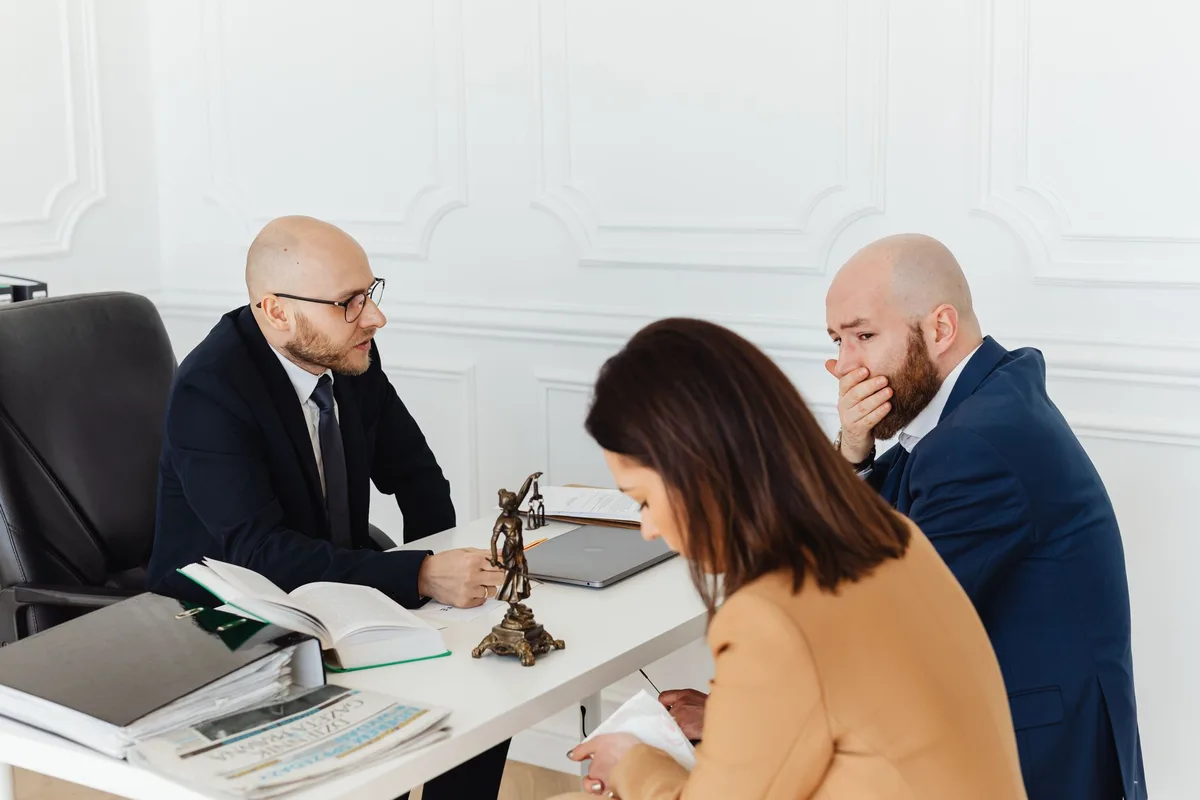 Professional consultation between a business owner and an attorney discussing legal strategy