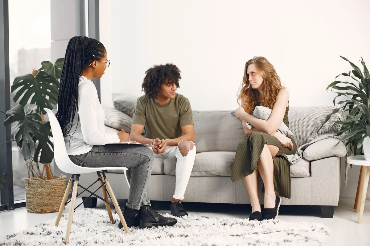 People in conversation at a community mental health event, showing open dialogue and peer support.