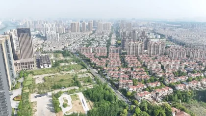 Aerial view of suburban residential development with construction sites and existing homes