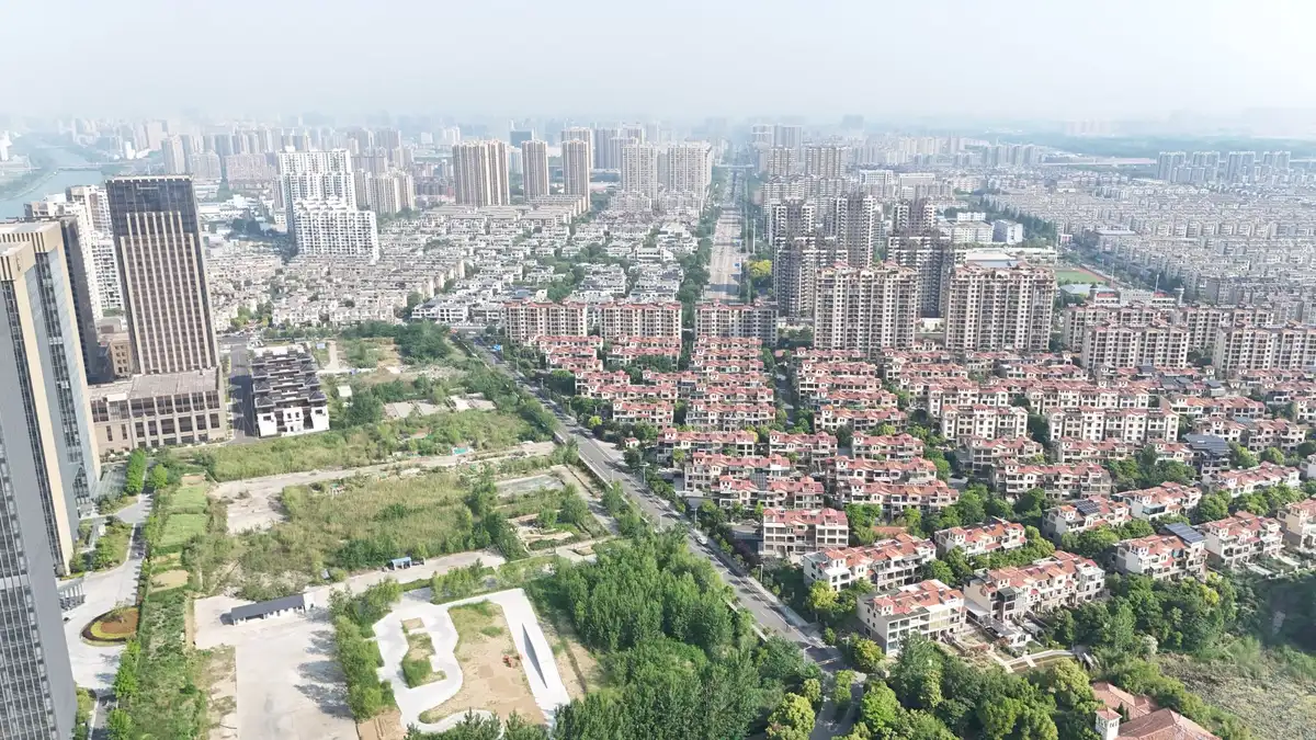 Aerial view of suburban residential development with construction sites and existing homes