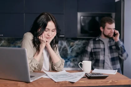 Person reviewing a utility bill and calendar during enrollment period