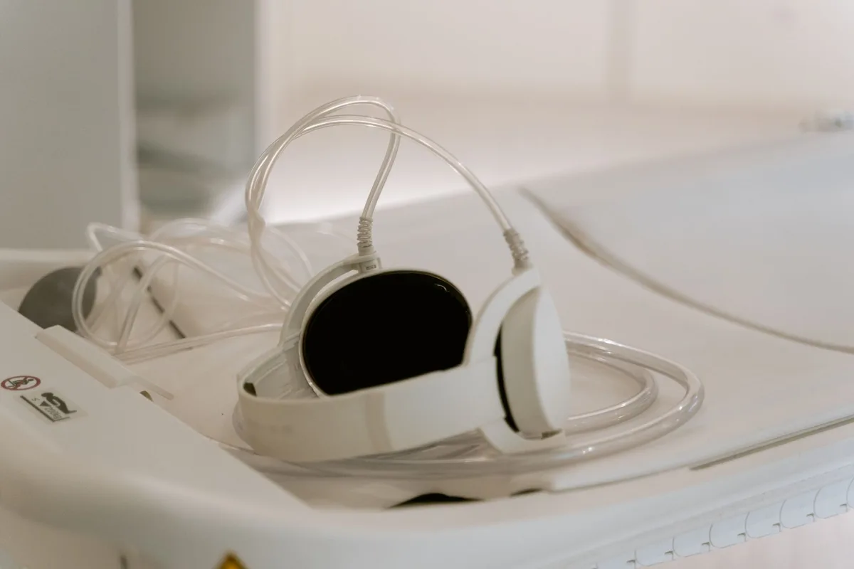 Person undergoing hearing assessment in an audiology clinic with specialized equipment