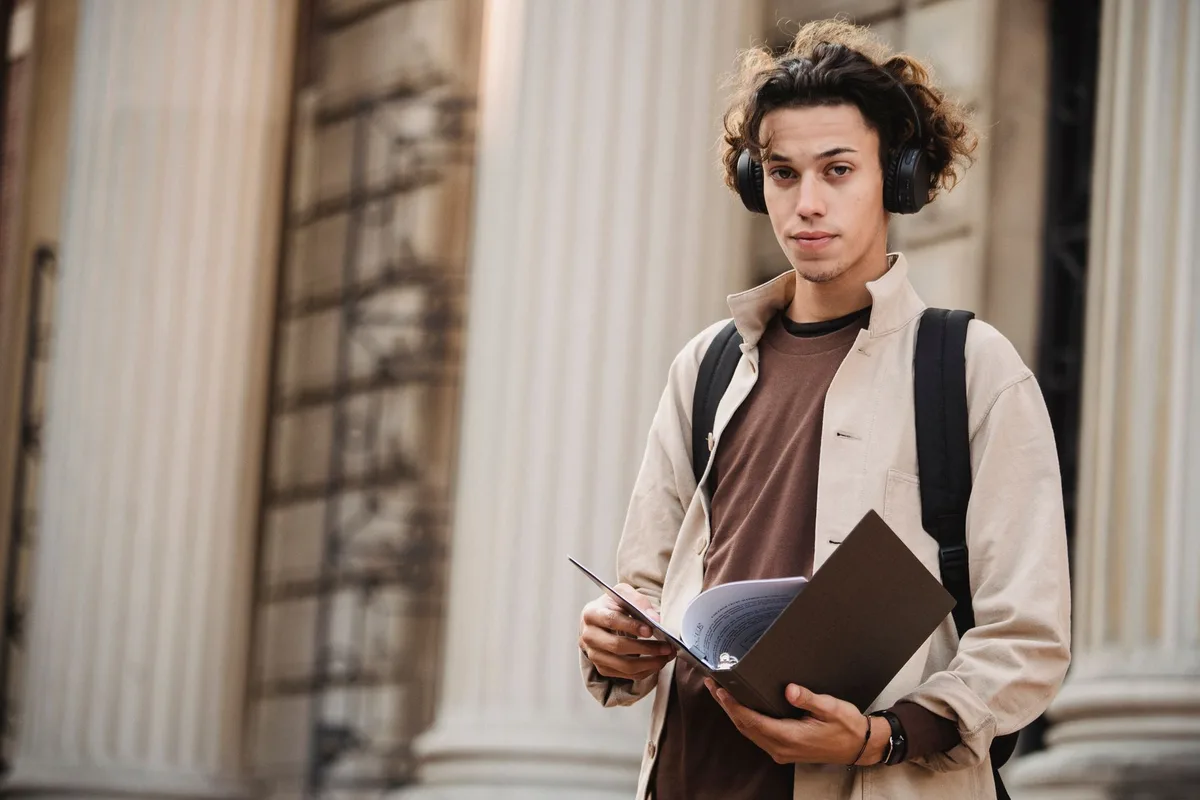 Journalism student studying at a university campus library or classroom