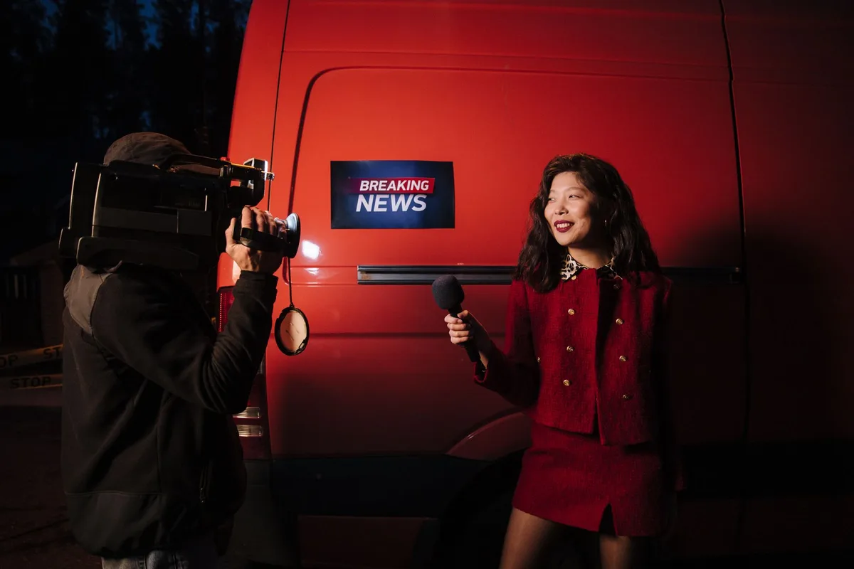 News reporter conducting interviews and reporting from the field in a community setting