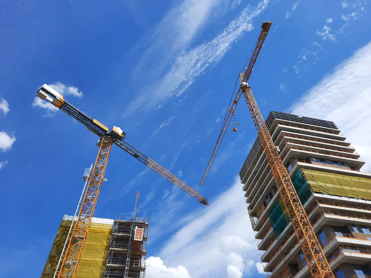 Construction equipment and cranes on a suburban commercial development site