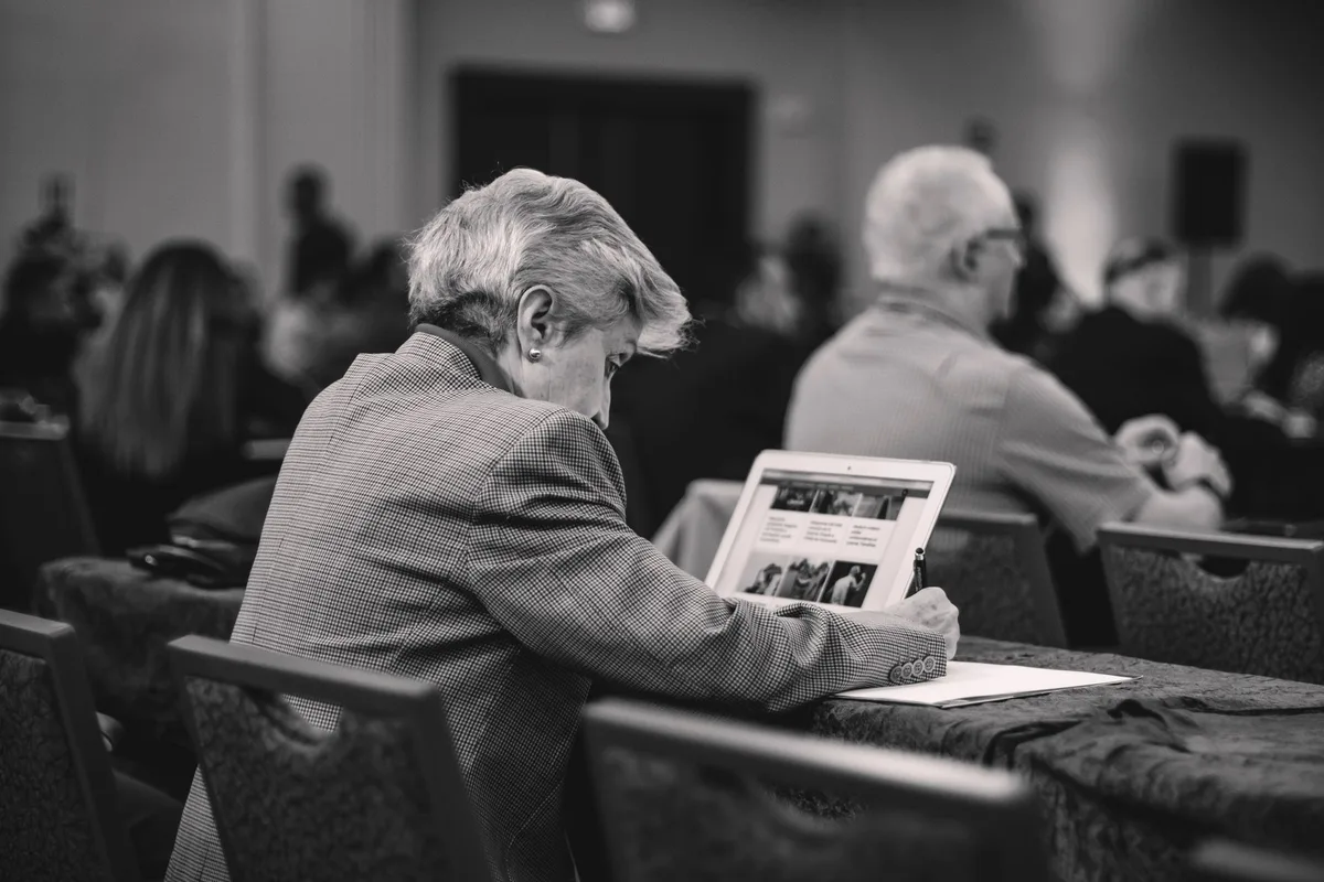 A journalist takes notes during a community interview or local reporting assignment.