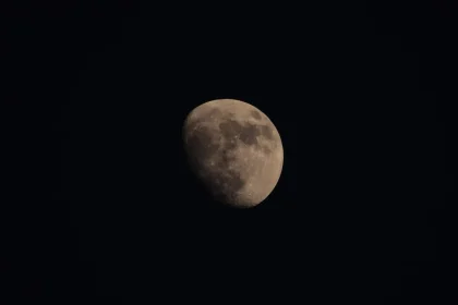 Night sky with lunar eclipse showing Earth's shadow covering most of the Moon