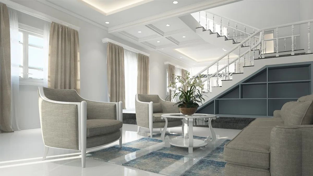 Spacious open-plan living room with high ceilings and expansive windows overlooking a lake