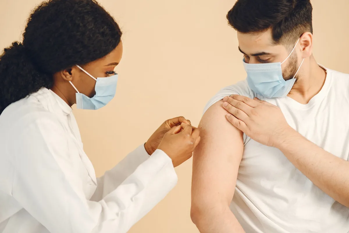 Community members receiving MMR vaccinations at a public health clinic