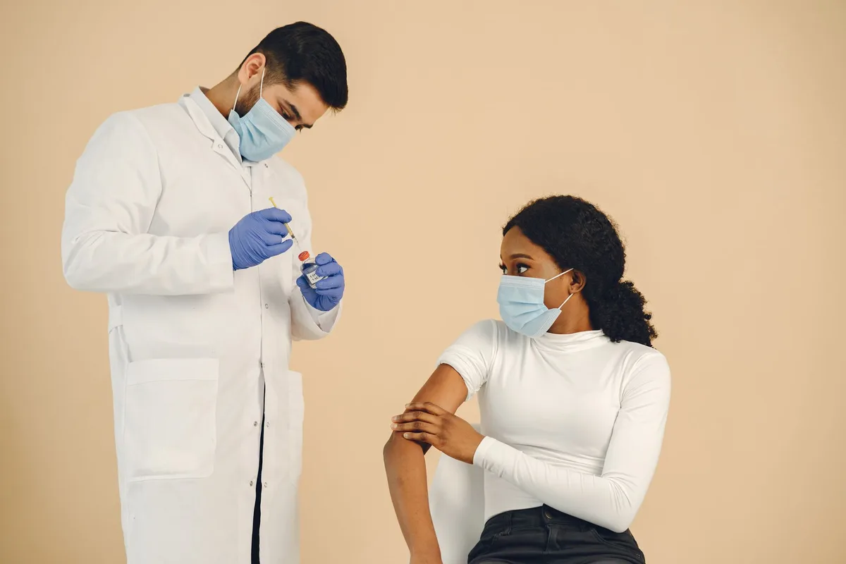 Healthcare workers administering vaccinations in a clinic setting