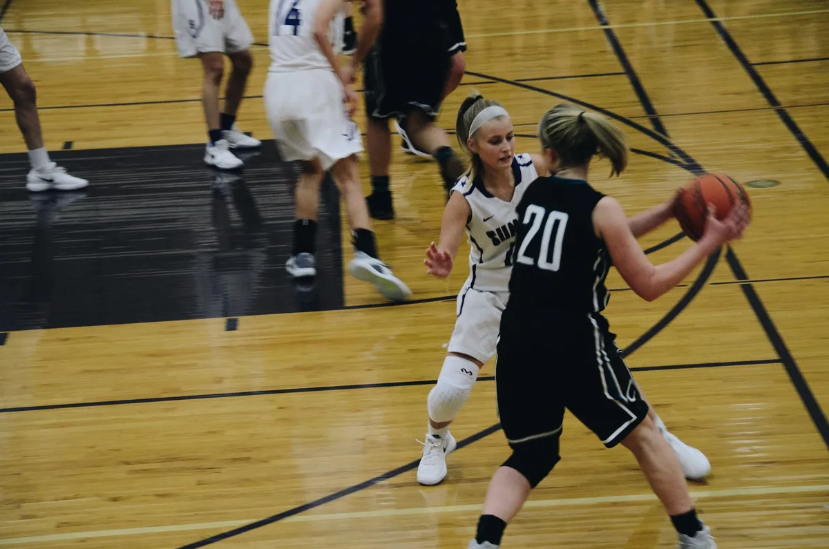 Point guard executing a pass during a college basketball game.