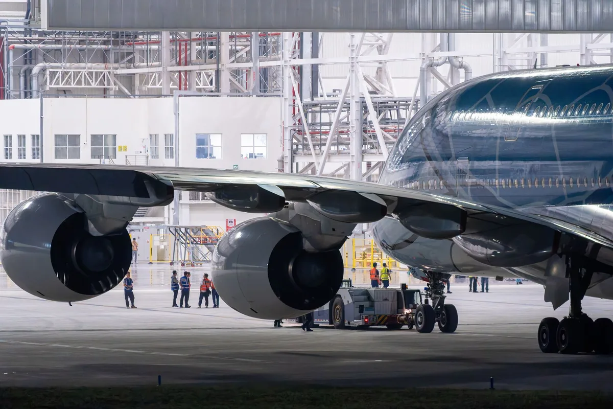 Technicians working on aircraft maintenance and repair in an MRO facility