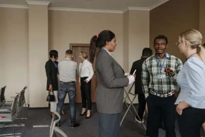 Professionals networking at an aerospace industry conference with aircraft models and technical displays on tables