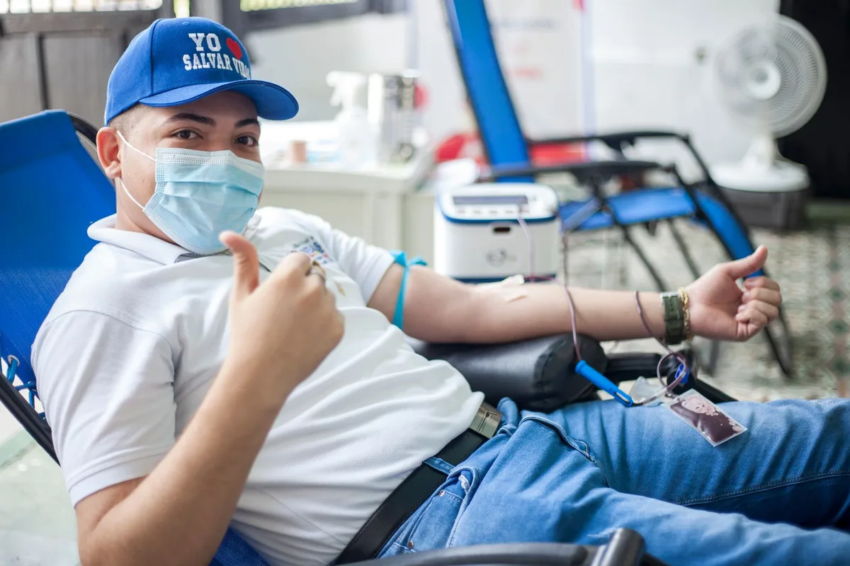 Blood donation center with donation chair and medical equipment in background
