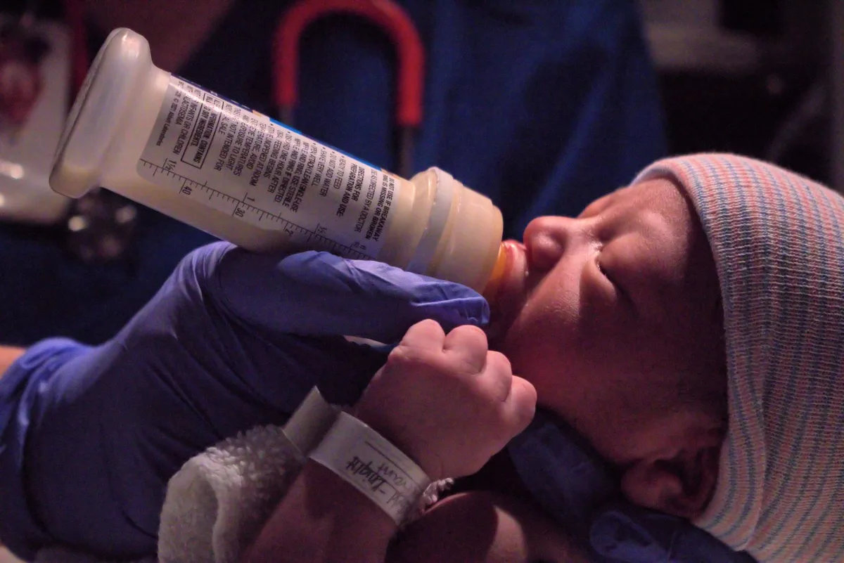 Medical professional examining an infant during a health assessment