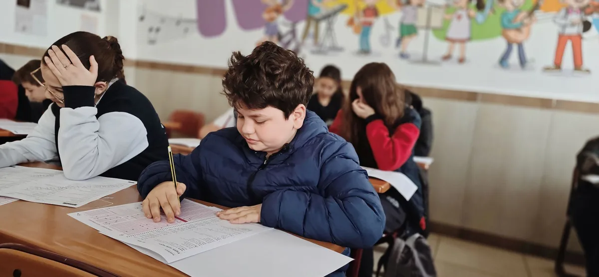 Student focused on schoolwork at classroom desk