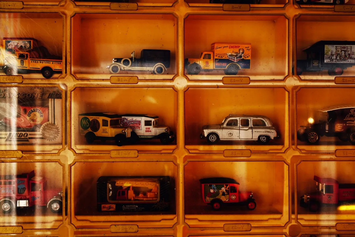 Vintage action figures and collectible items arranged in museum display cases