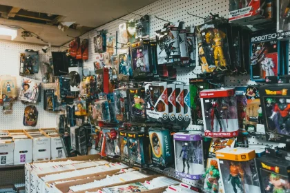 Shelves of vintage action figures and collectible toys in glass display cases