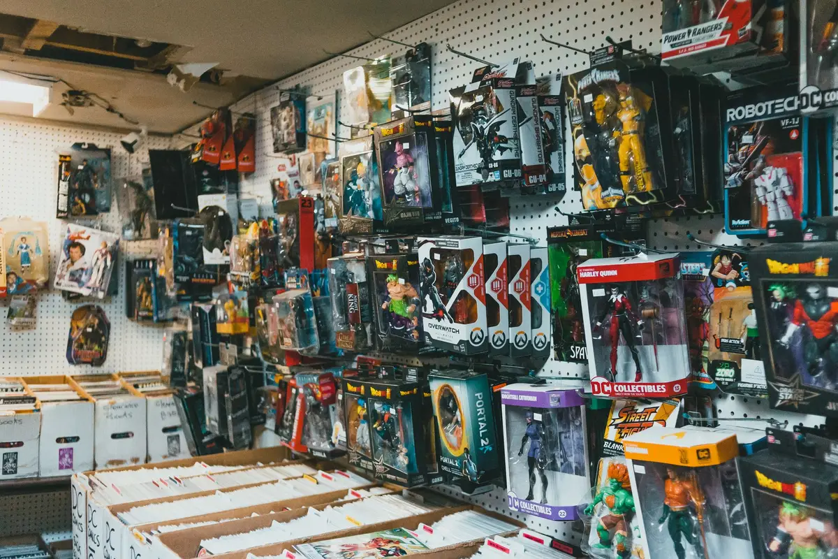 Shelves of vintage action figures and collectible toys in glass display cases
