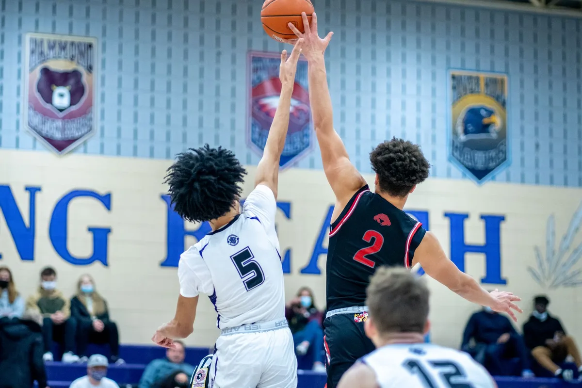 High school basketball player in action during a game, scoring or celebrating