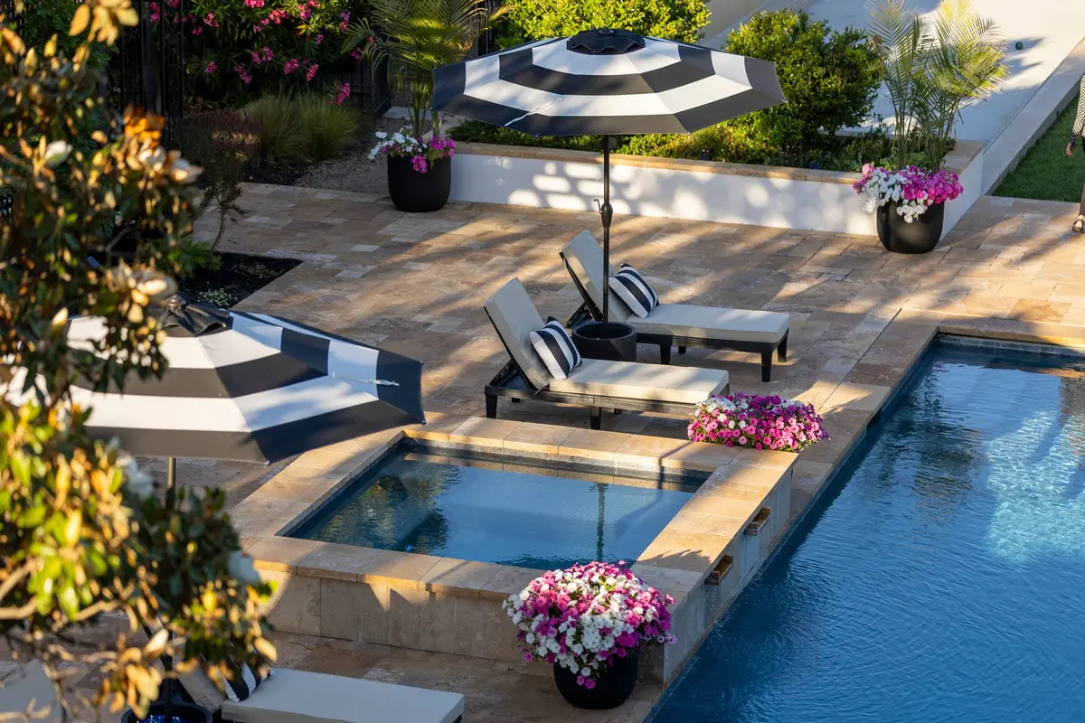 Resort-style backyard pool overlooking landscaped grounds and river valley views