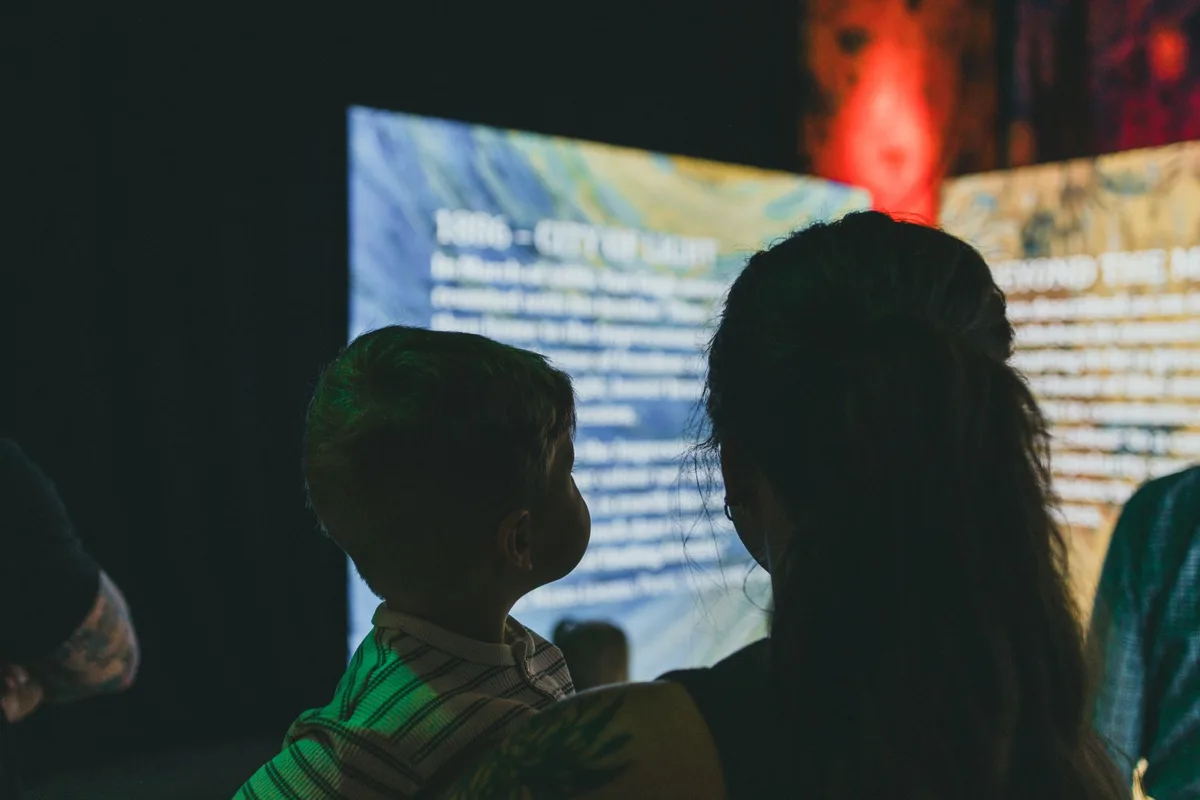 Children exploring interactive career stations and trying on costumes at a museum exhibit