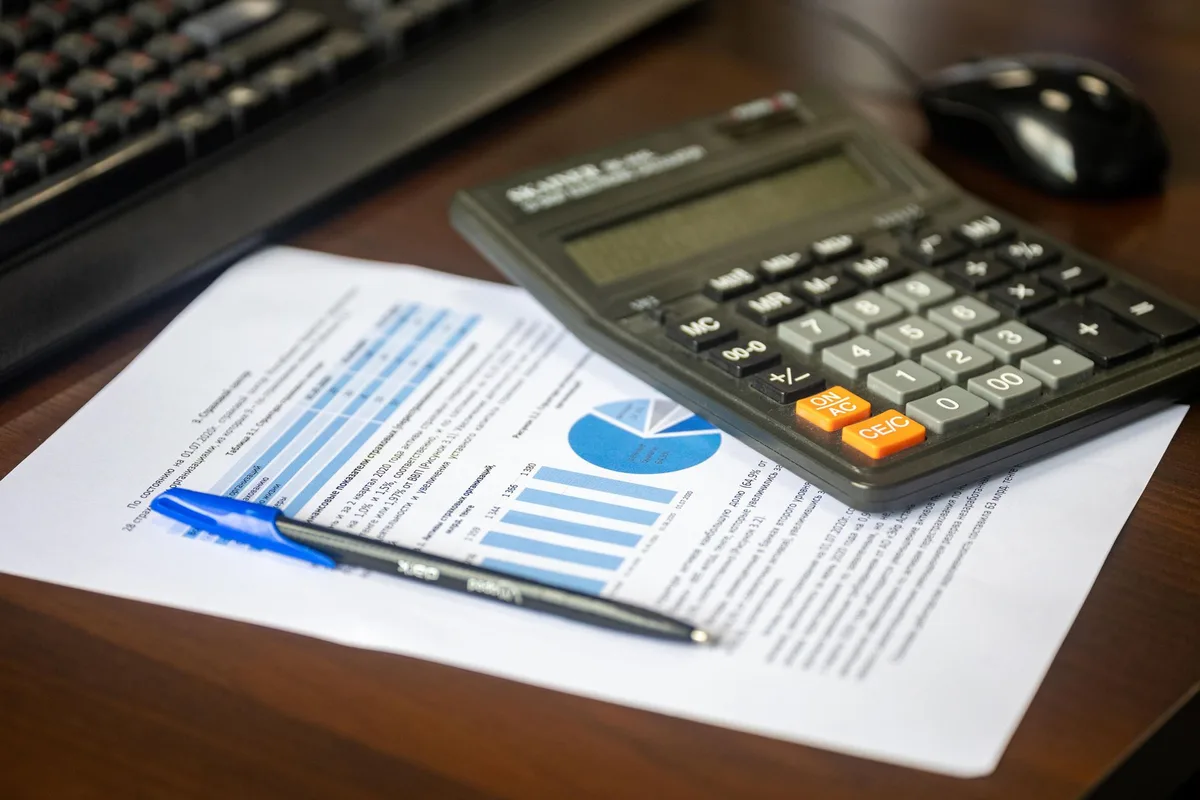 Person reviewing retirement budget and bills at home desk