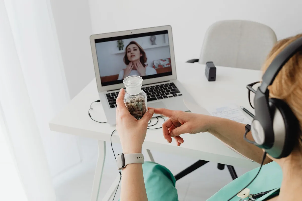 Healthcare provider assisting patient via telehealth in a rural medical setting