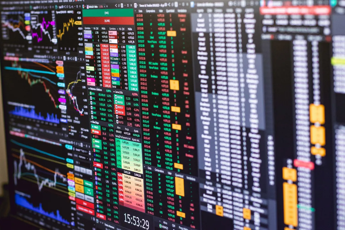 Traders monitoring real-time stock market data on multiple screens