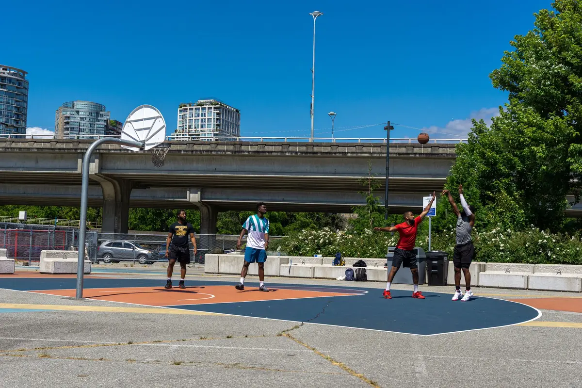 Basketball player releasing a three-point shot during game action
