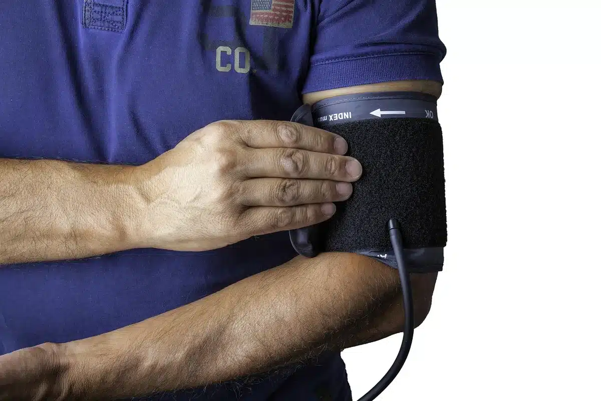 Healthcare worker performing blood pressure screening at a community health event