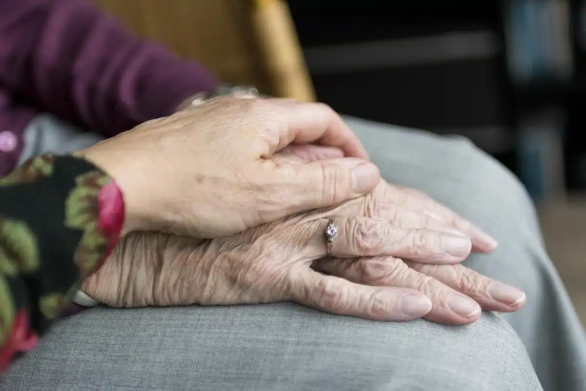 Parent holding a child's hand in a clinic waiting room
