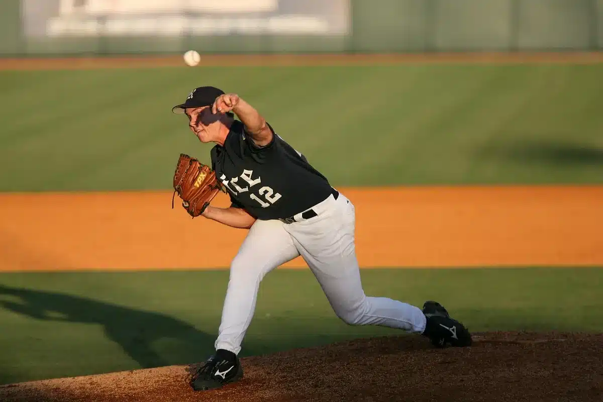 A relief pitcher throwing during a crucial moment in a high school baseball game