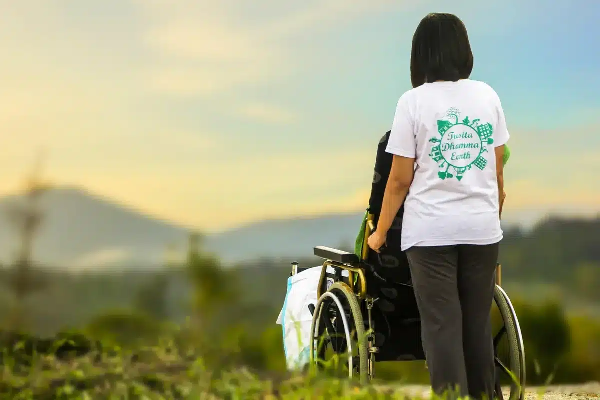 Healthcare worker assisting an elderly patient, representing growing demand for care services