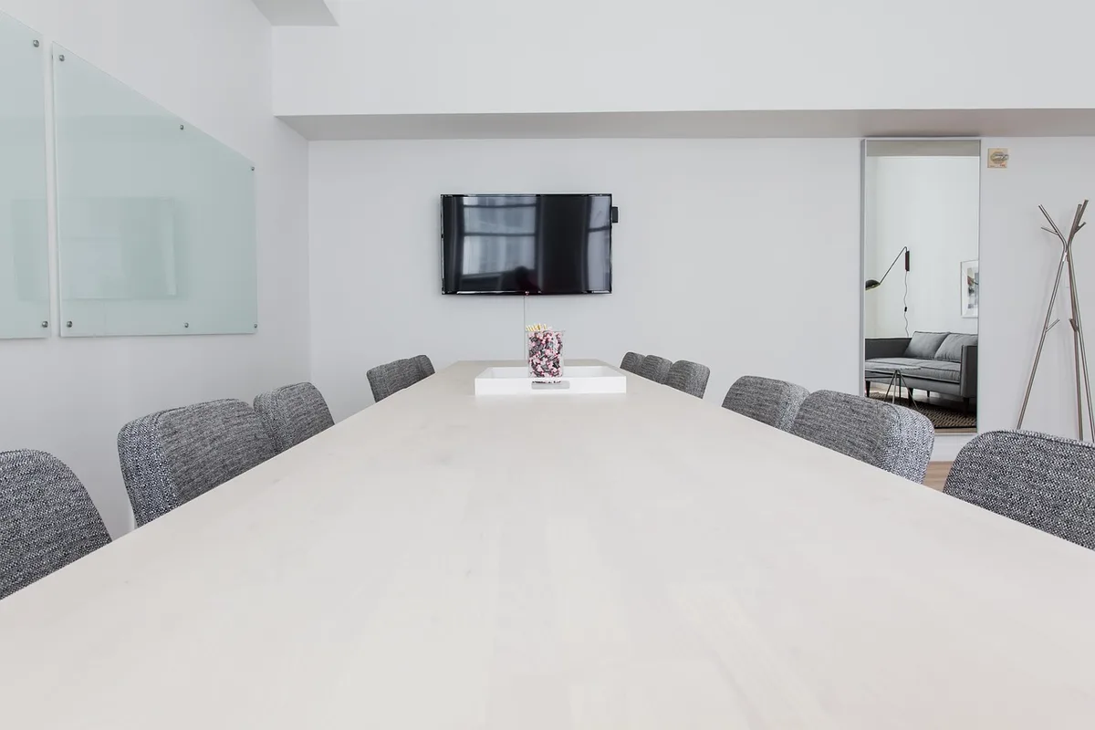 Local small-business owner and advisor discussing plans at a daylight office table