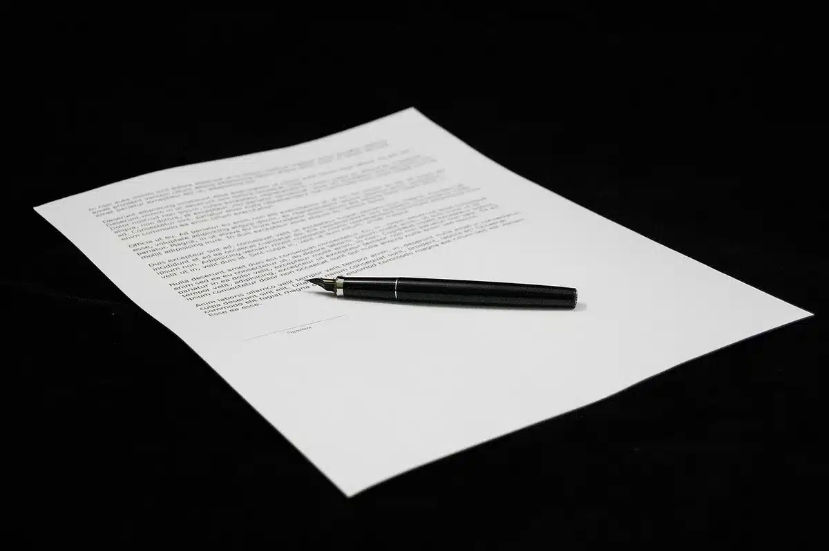 Hands comparing two insurance policy documents