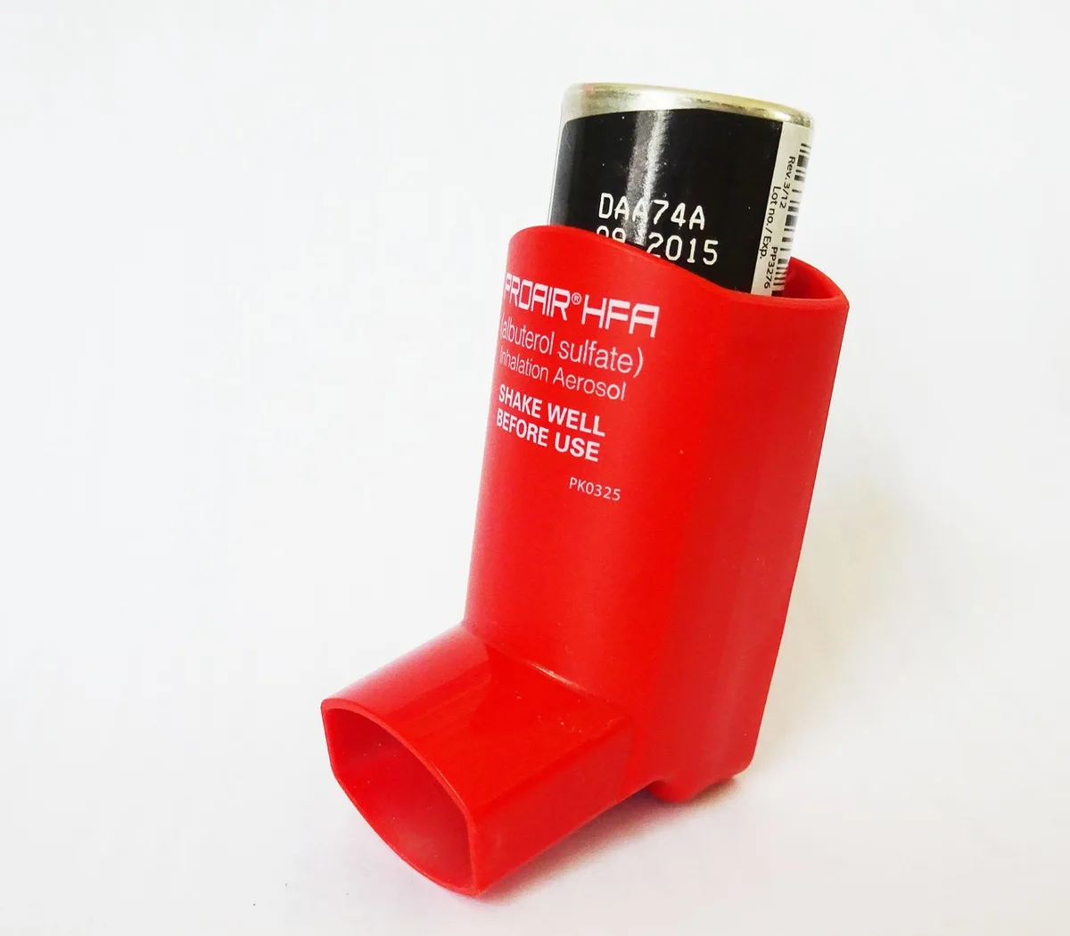 Person using a rescue inhaler to manage asthma symptoms during poor air quality