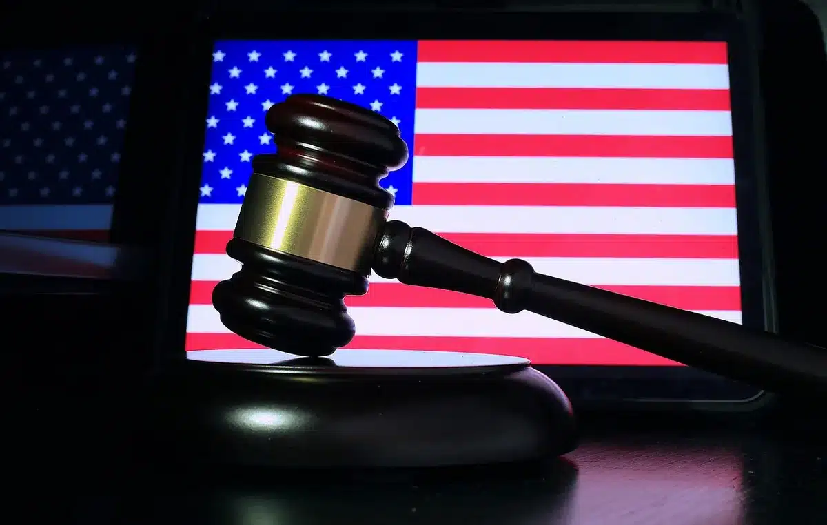 Gavel beside legal filings on a bright office desk