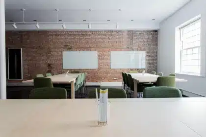 Empty classroom with textbooks on desks and a teacher's lanyard, late-afternoon light