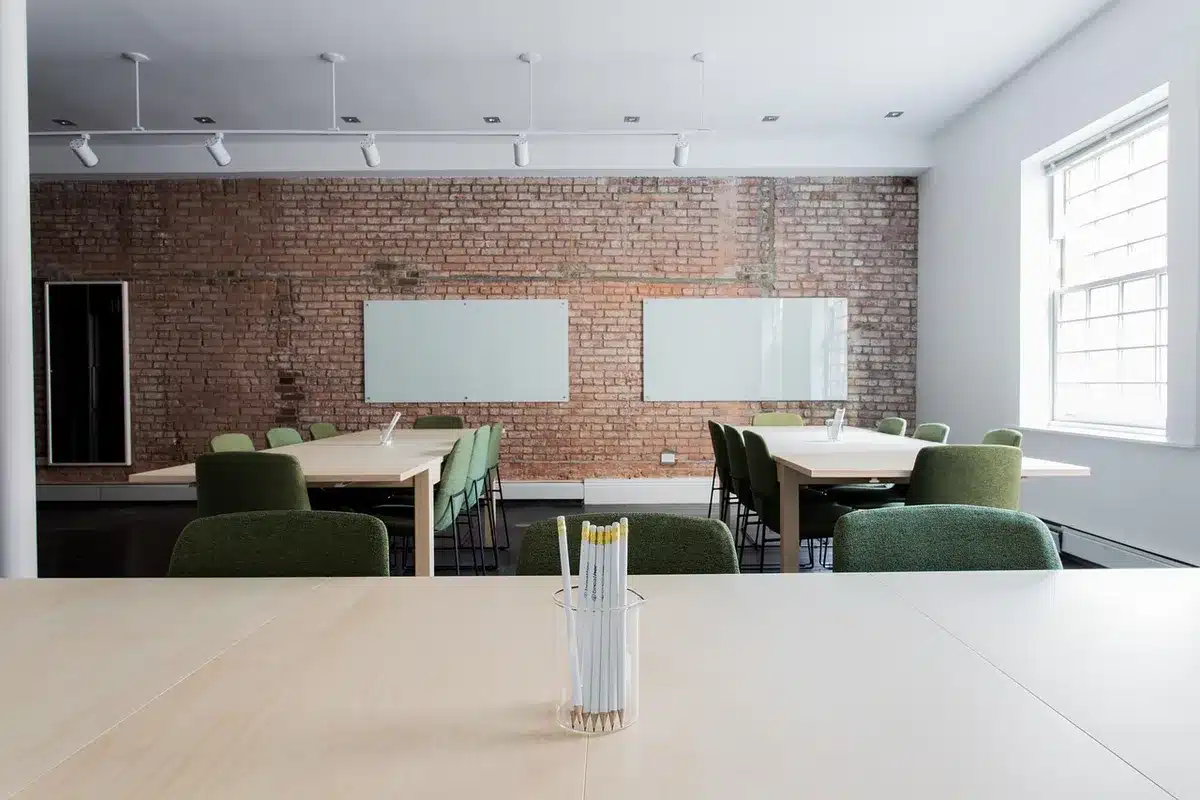 Empty classroom with textbooks on desks and a teacher's lanyard, late-afternoon light