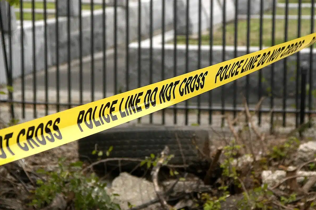 Police tape and officers near a campsite being investigated