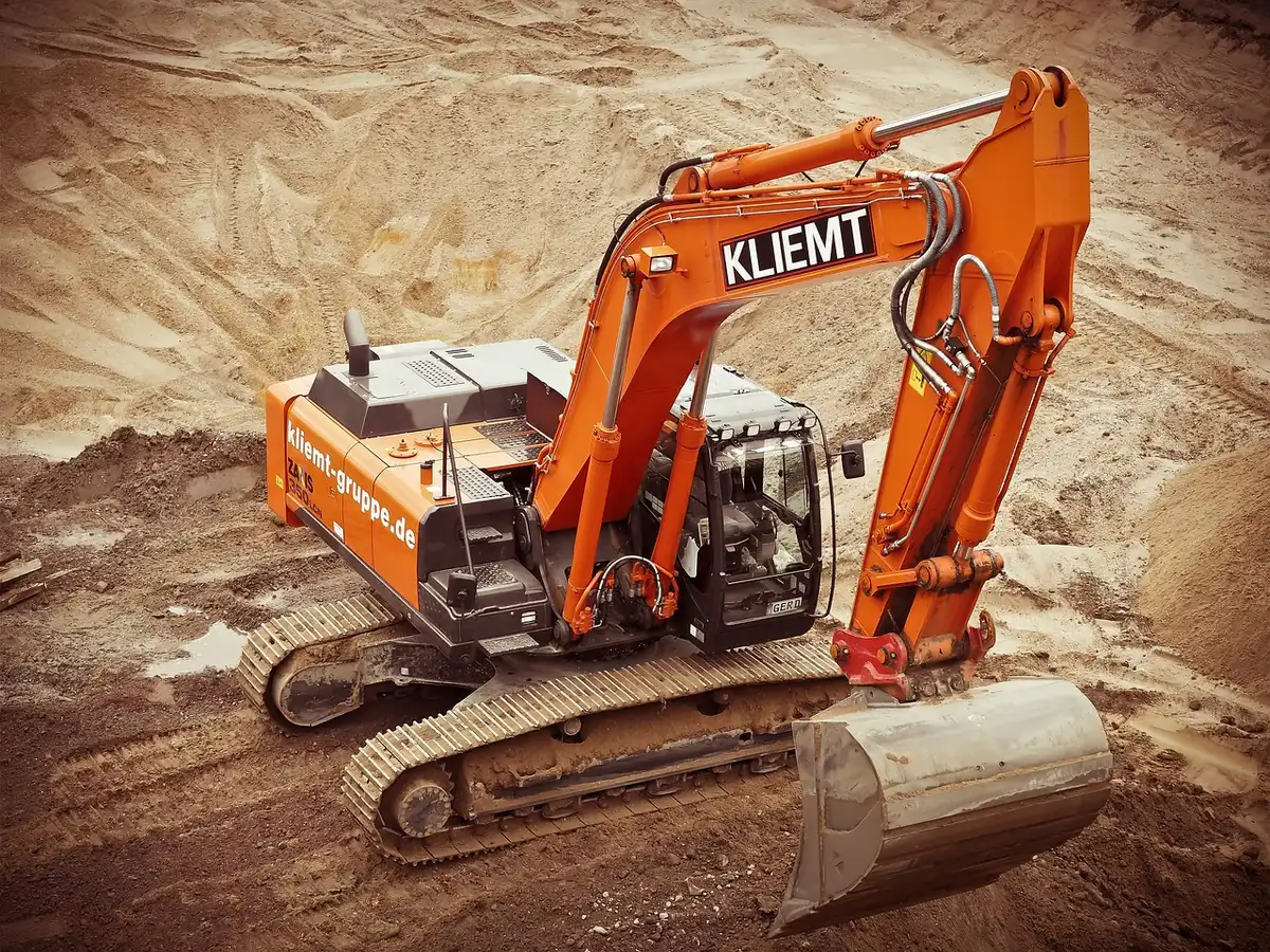 Idle construction equipment and paused site work at a property