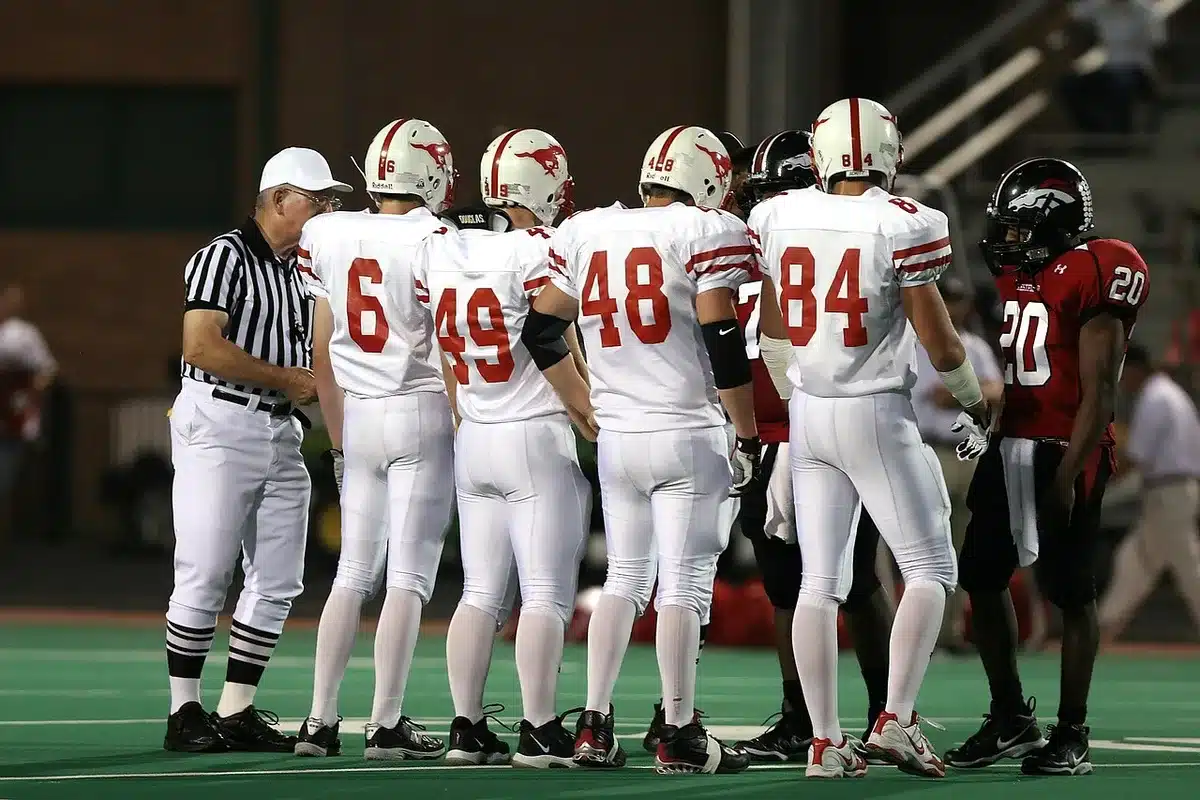 Group of high-school players in practice huddle showing veteran leaders