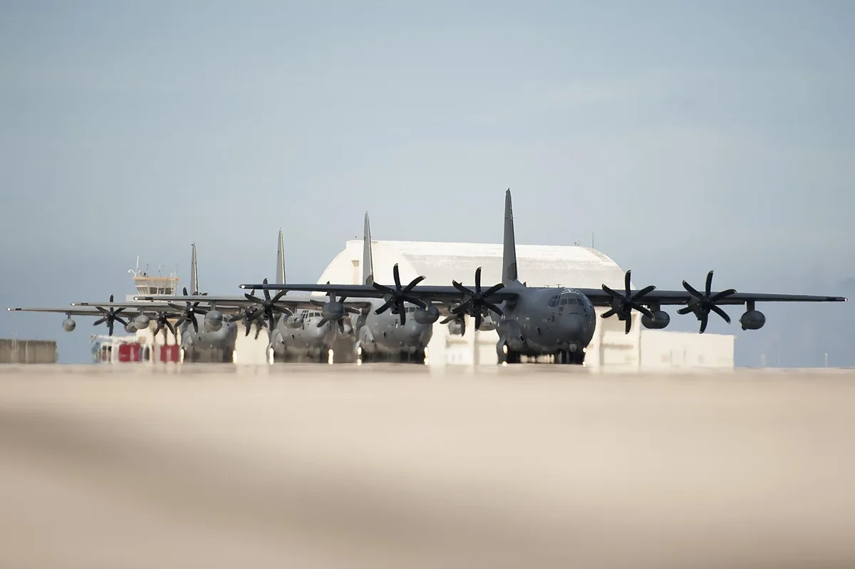 Large military maintenance hangar and parked aircraft at a base