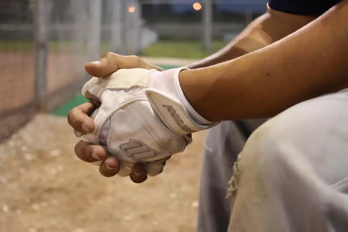 Batter at the plate on a sunlit high-school baseball field