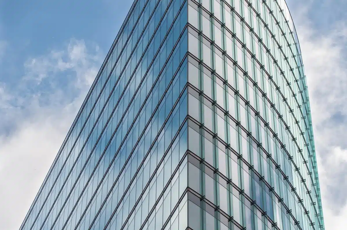 Historic brick-and-glass office tower with scaffolding and daytime street activity