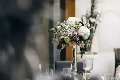 People at a daytime venue lobby exchanging raffle tickets next to a table of memorabilia