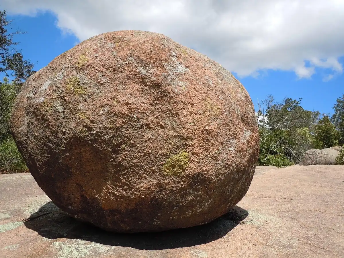 Granite boulders and hikers scrambling in a rugged refuge area