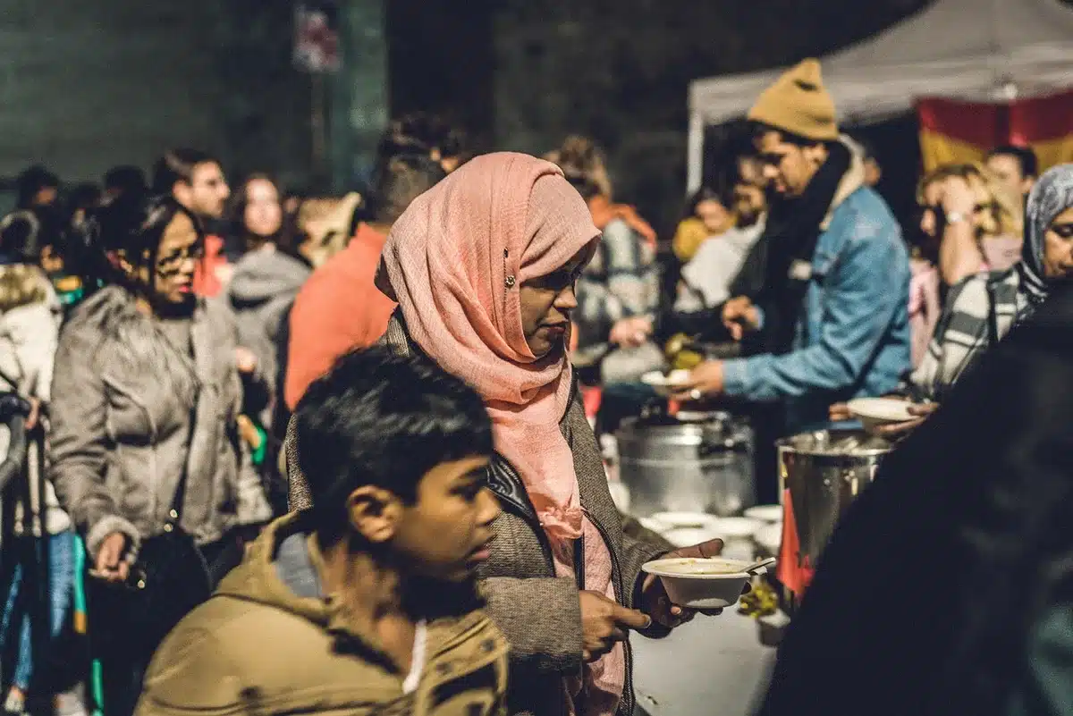 Volunteers handing out food at an outdoor distribution table
